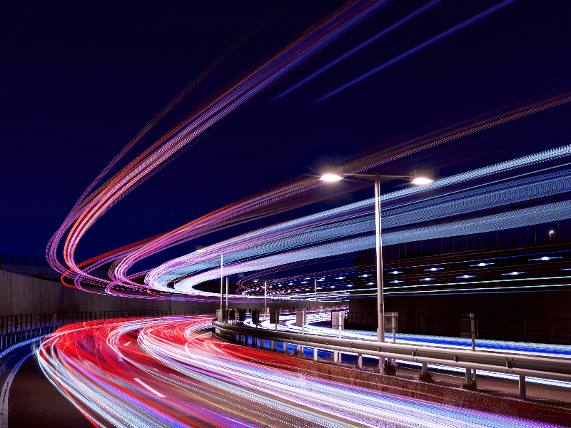 Background image with abstract light motion of highway at night to complement message of speed of migration to Windows 11.